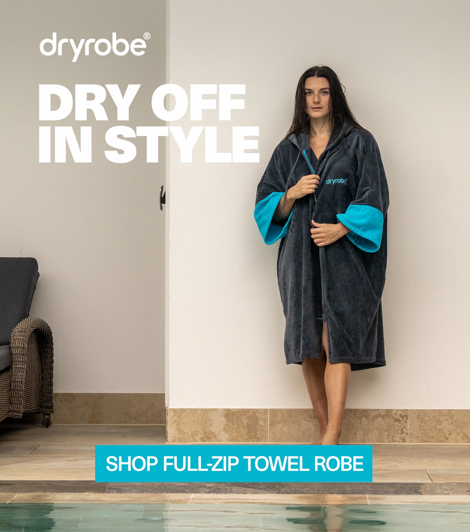 Woman beside a pool in a spa wearing a zip up towel robe