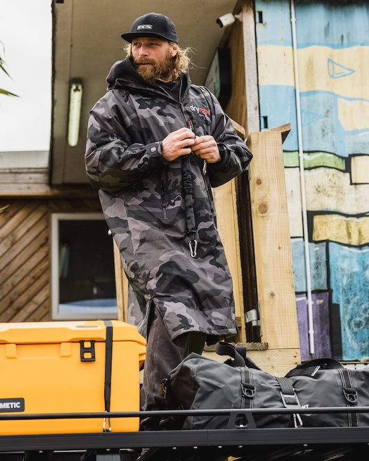 Ben Skinner wearing a dryrobe® while packing up his Land Rover