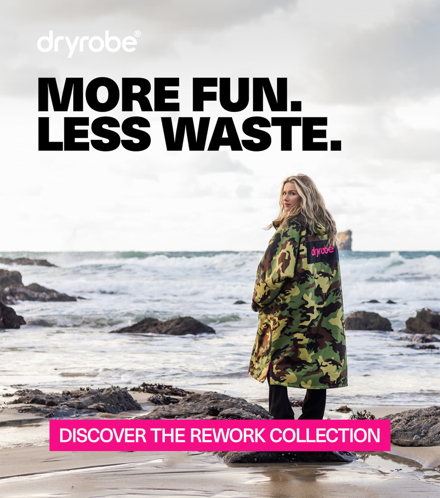 Woman on the beach wearing a changing robe in autumnal weather