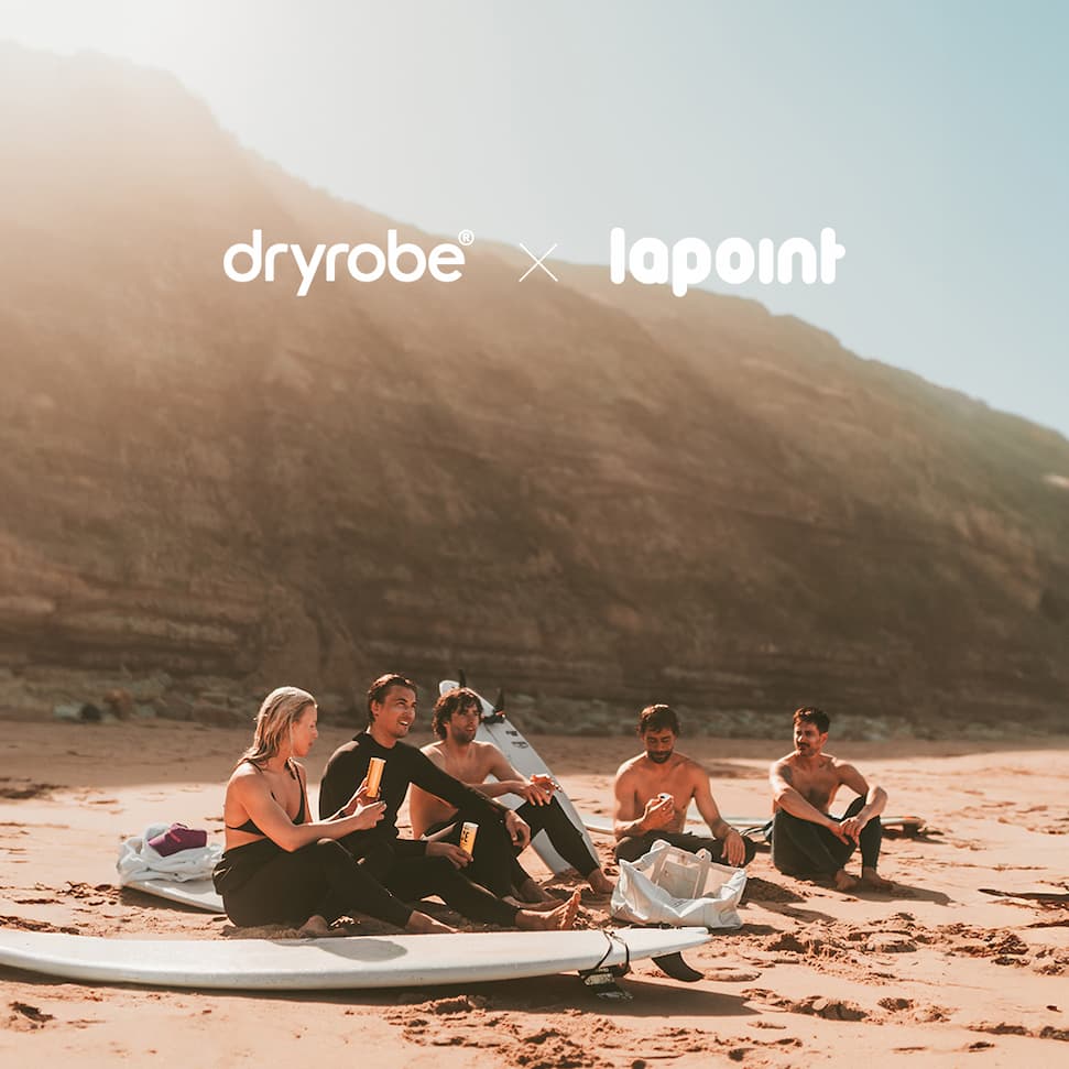 Friends gathered on the beach with surfboards after a session in the water