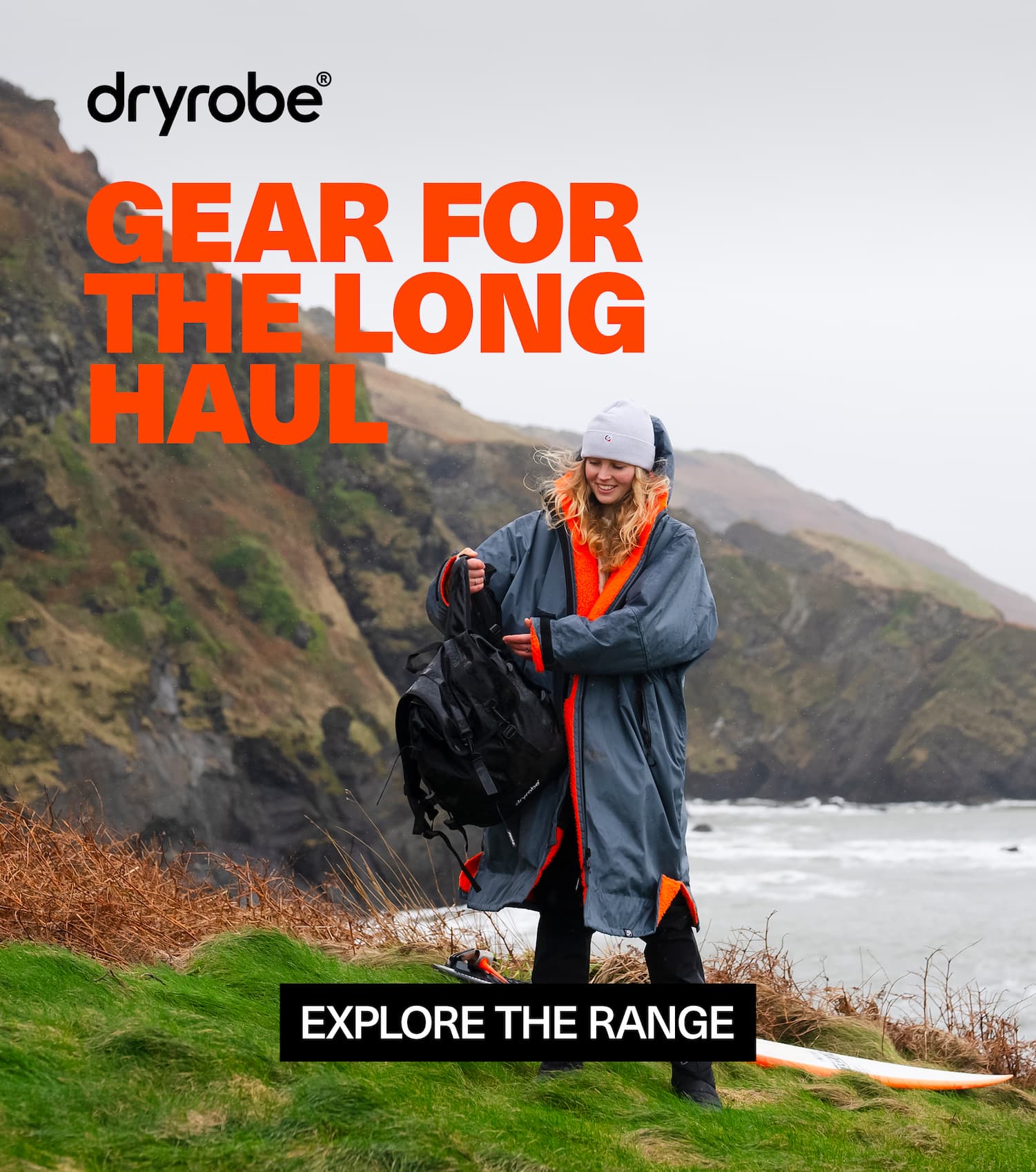 Woman on the cliffs wearing a long lasting Dryrobe® changing robe