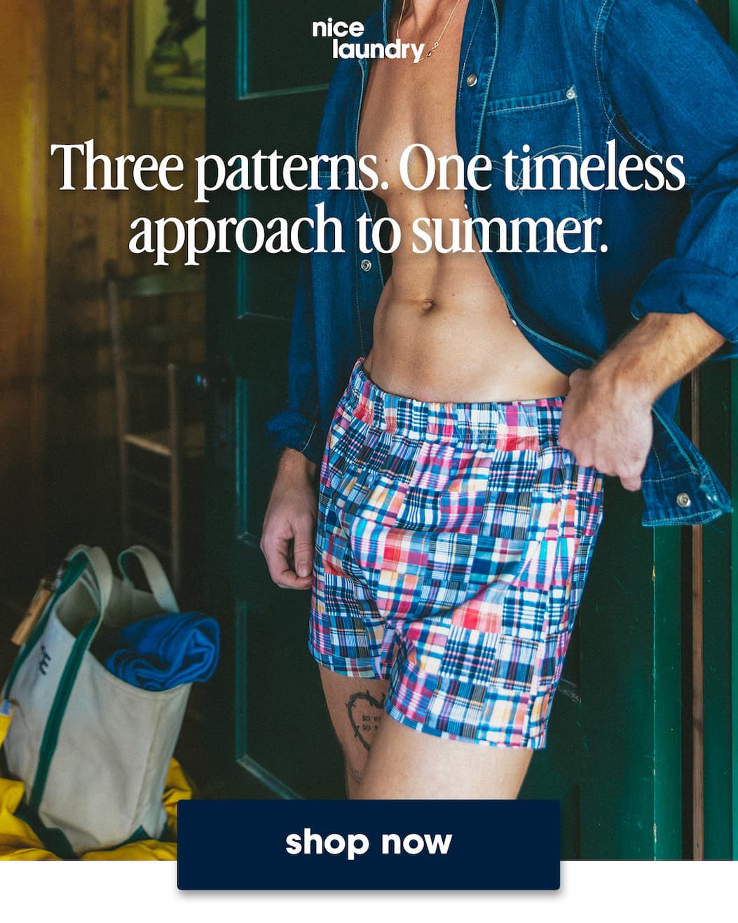 Man standing in doorway wearing open denim shirt and classic madras print slim fit boxers