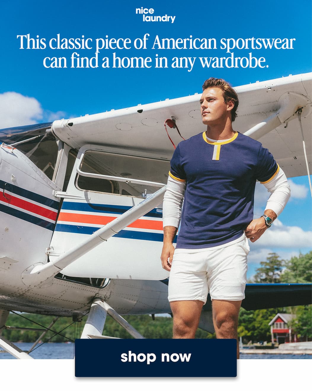 Man wearing navy ringer t-shirt and cream lounge shorts standing in front of a small plane. Text on image says "this classic piece of american sports wear fan find a home in any wardrobe"