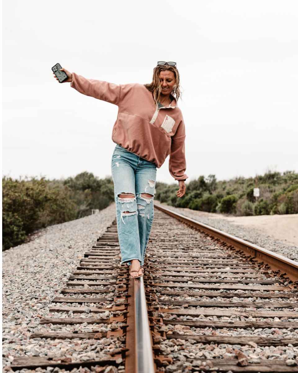 lakey peterson walking on train tracks in san clemente.