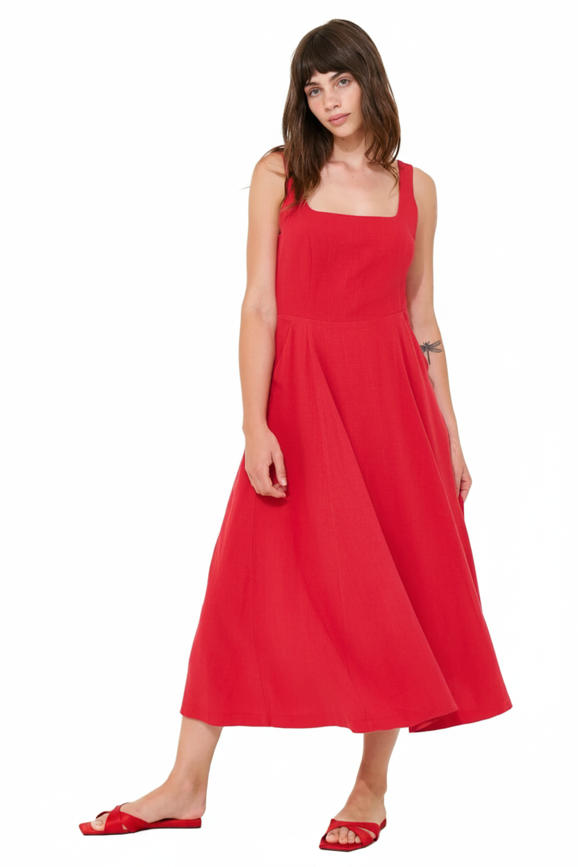 Woman in a red square-neck midi dress and red slide sandals.