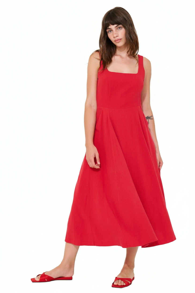 Woman in a red square-neck midi dress and red slide sandals.