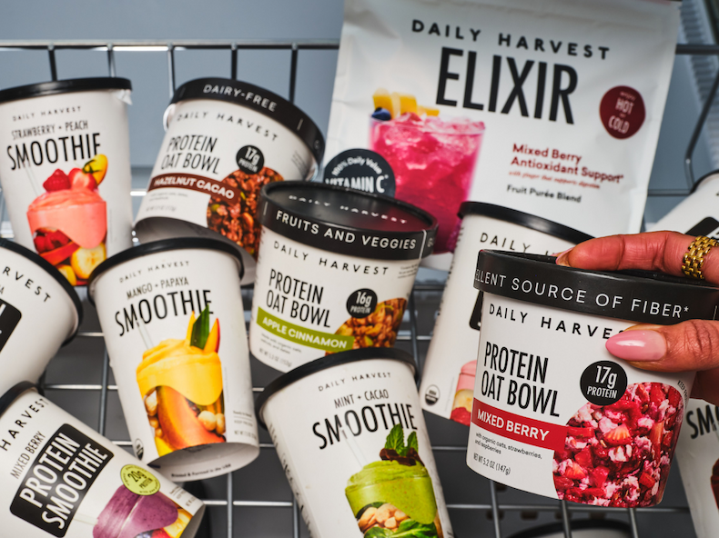Assortment of Daily Harvest Smoothies, High Protein Oat Bowls, and Elixirs arranged together.
