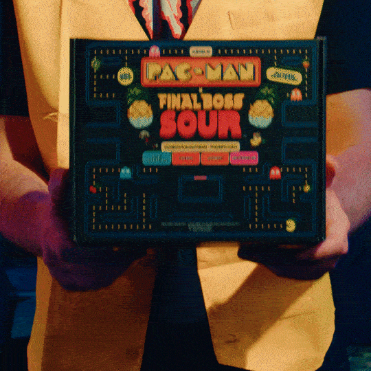 Man happily eats PAC-MAN Level 3 Pineapple Dippers