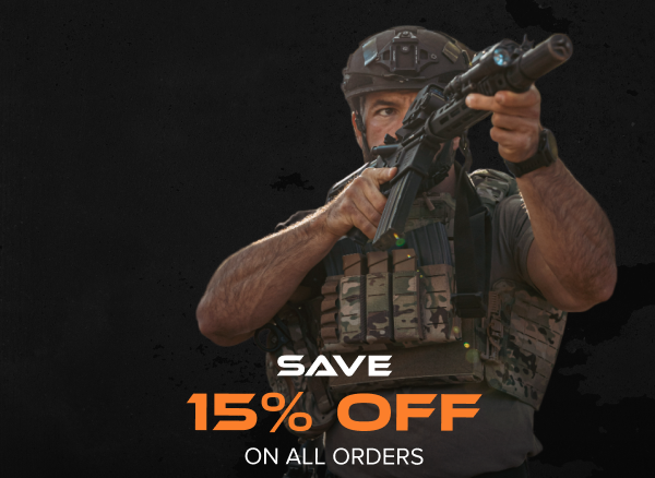 Officer in tactical gear aiming rifle.