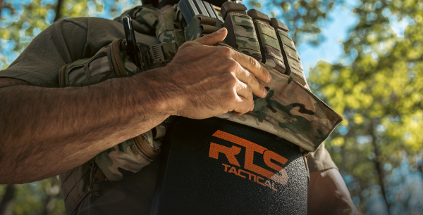 Image of man holding a body armor plate with a RTS Tactical plate carrier