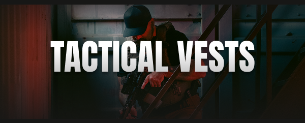 Officer in tactical vest aiming while clearing a stairwell