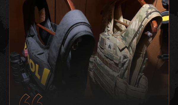 Black police plate carrier and camouflage tactical plate carrier hanging side by side.