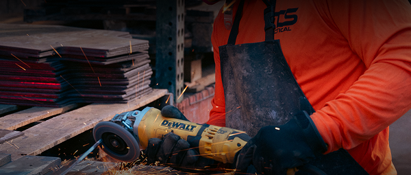 Worker grinding metal plates with sparks flying