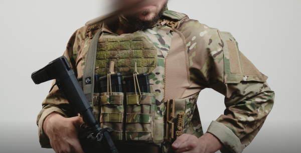 Operator wearing RTS Tactical plate carrier and rifle magazines in multicam uniform