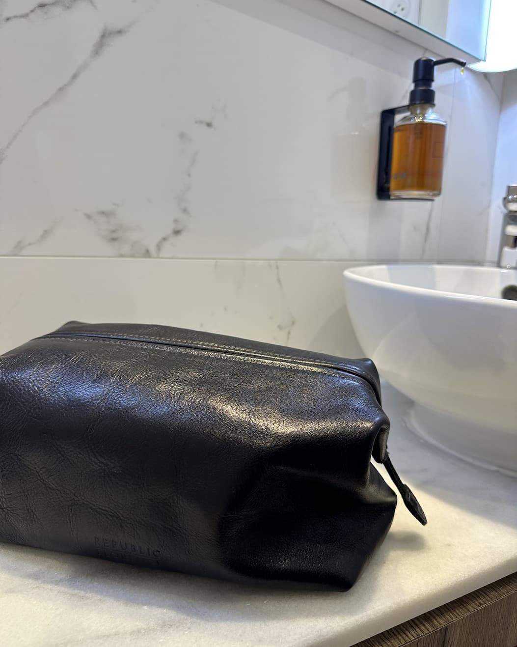 The Grand Dopp in black, on the bathroom counter.
