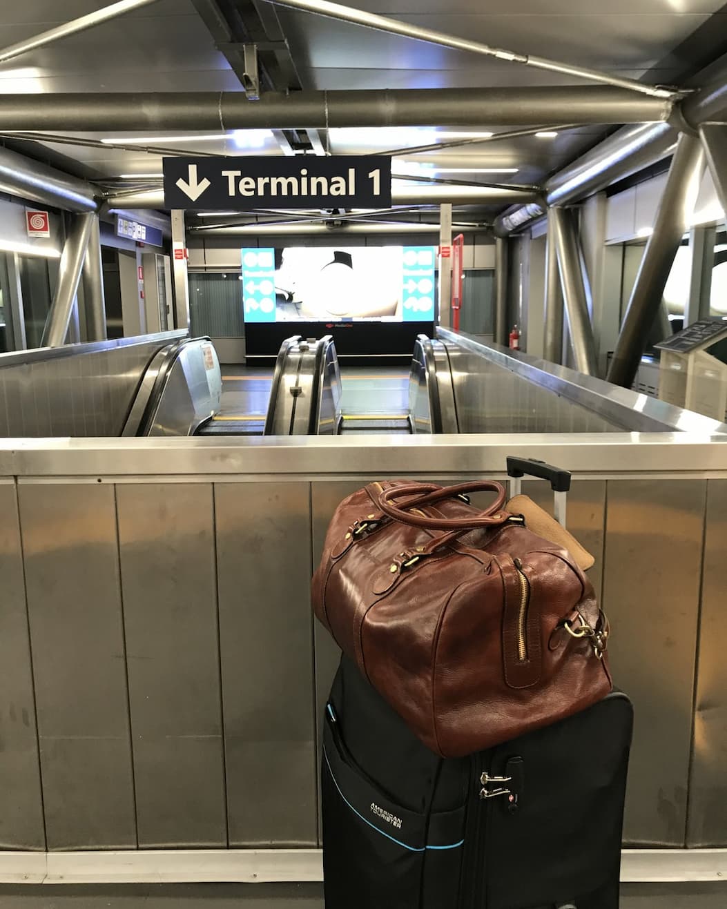 The Beltrami riding on top of a wheeled case, heading for Terminal 1.
