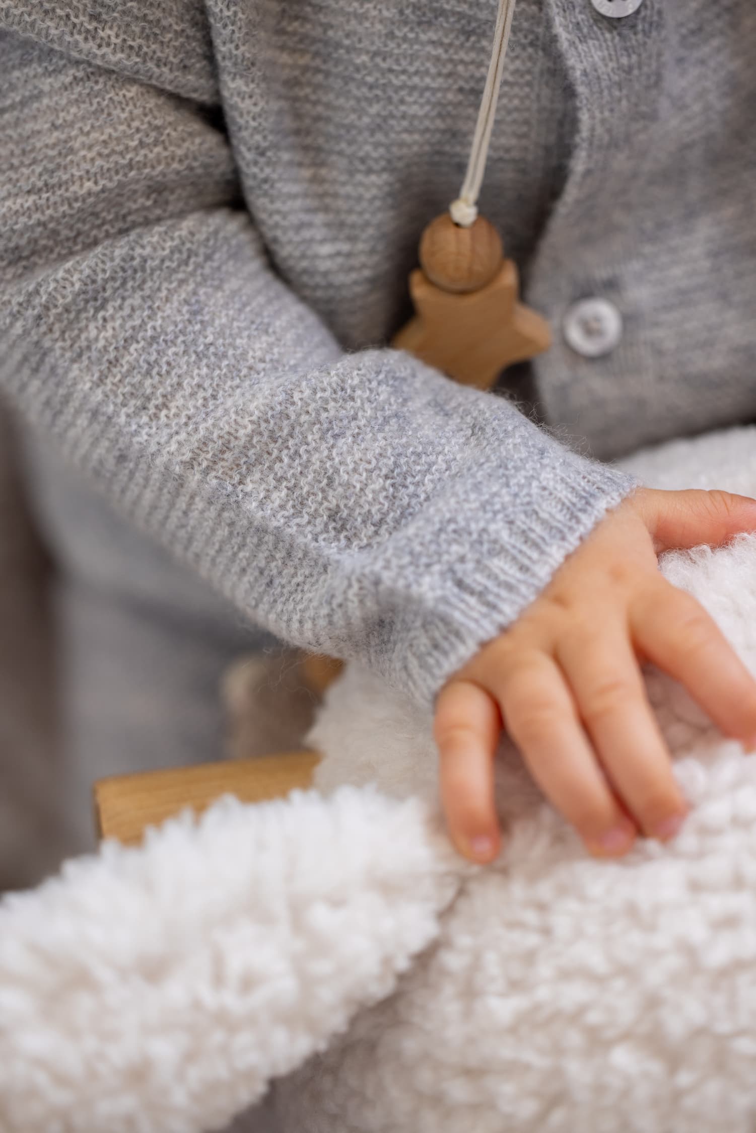 Detailaufnahme von Babyhand in Baby Overall ANOUK