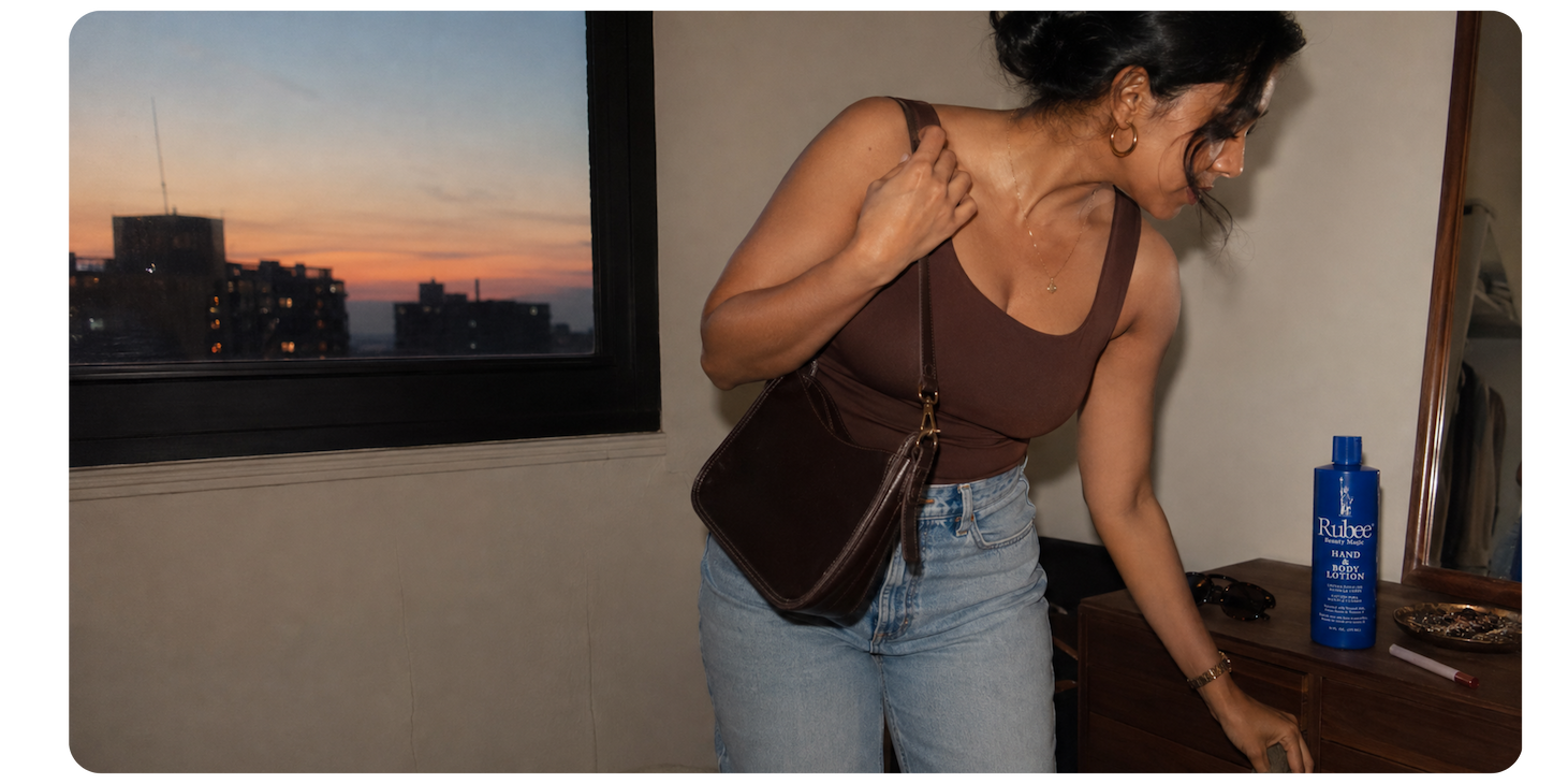 A woman getting ready to go out, with Rubee Beauty Magic on her dresser