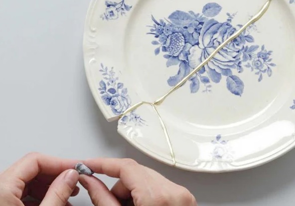 A plate being mended and improved by Kintsugi