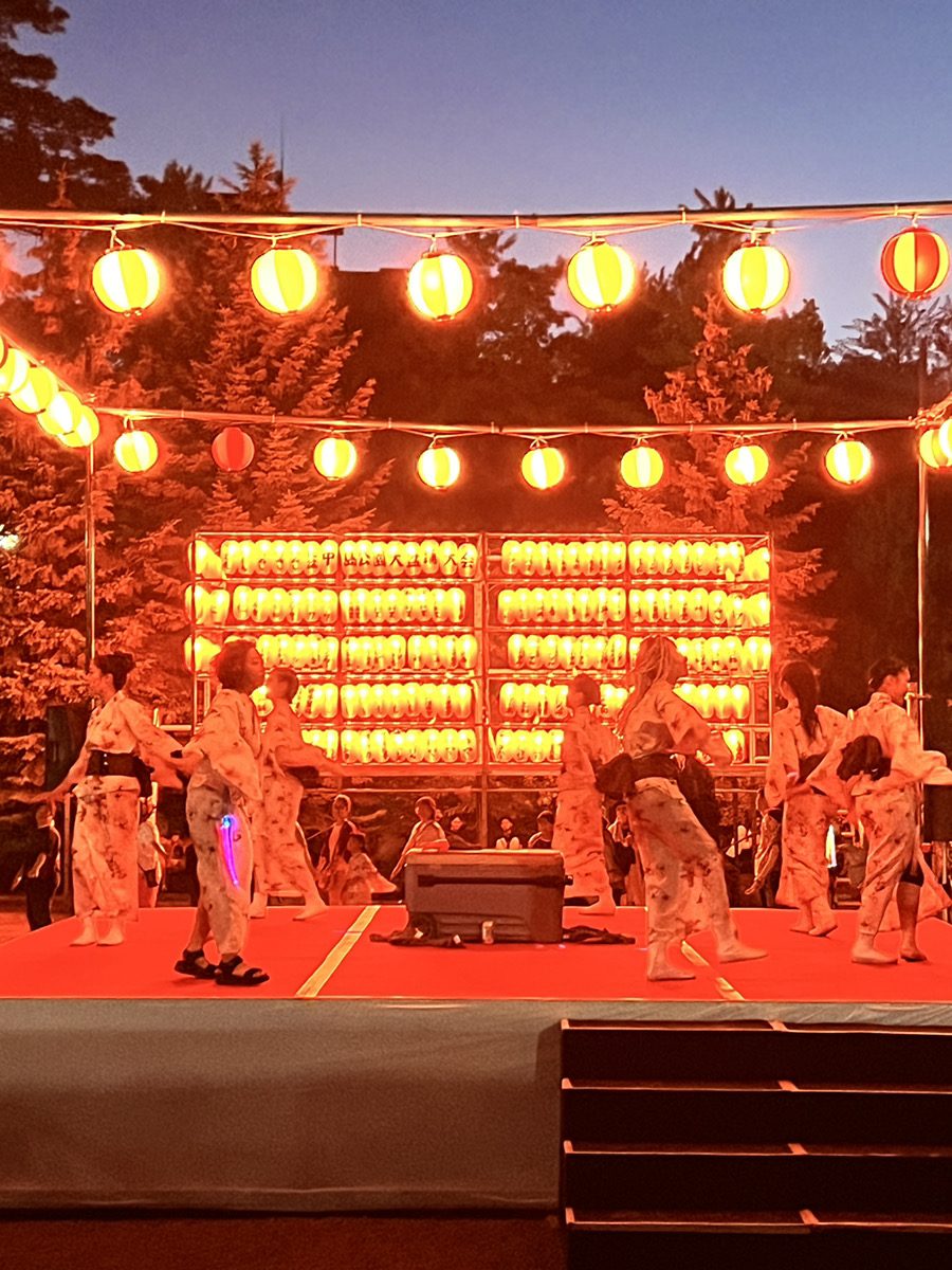Dancers on a low stage at dusk