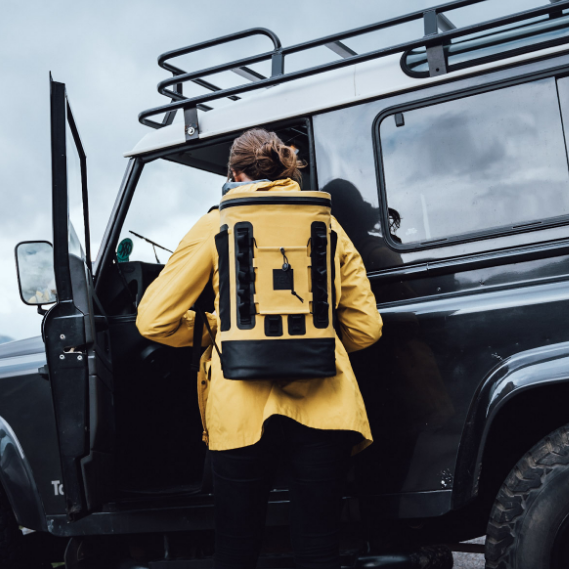 Woman wearing Red Original's Waterproof Cool bag Backpack in Mustard