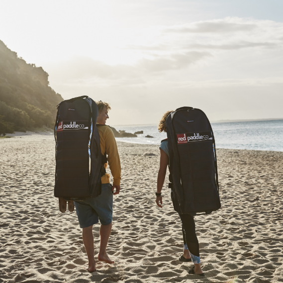 Two friends carrying their board in Red Original's ATB Board Bags