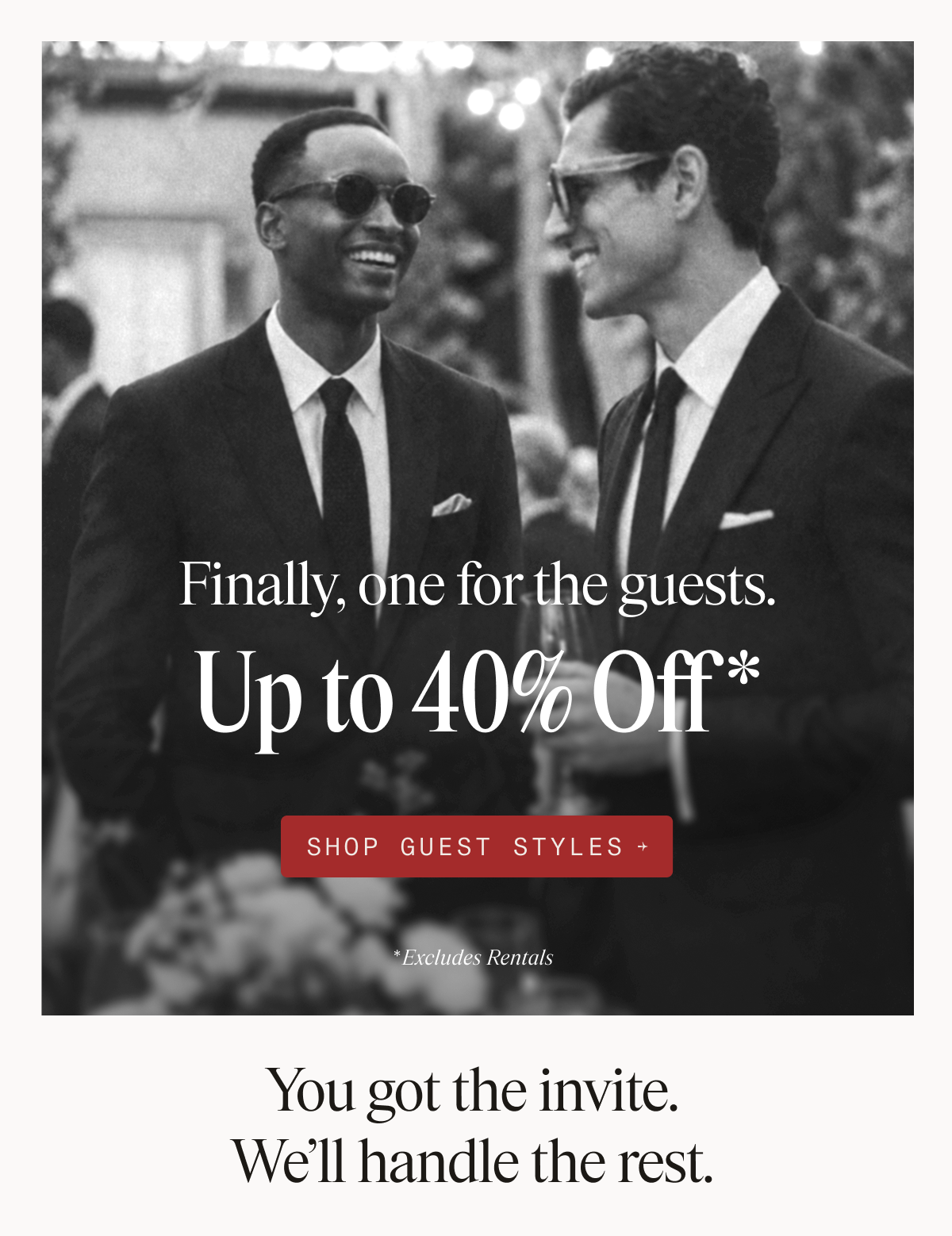 Black and white photo of two men in dark suits and sunglasses smiling at each other at an outdoor event, with text overlaid reading: Finally, one for the guests. Up to 40% Off* SHOP GUEST STYLES → *Excludes Rentals. Below the photo, text reads: You got the invite. We'll handle the rest.