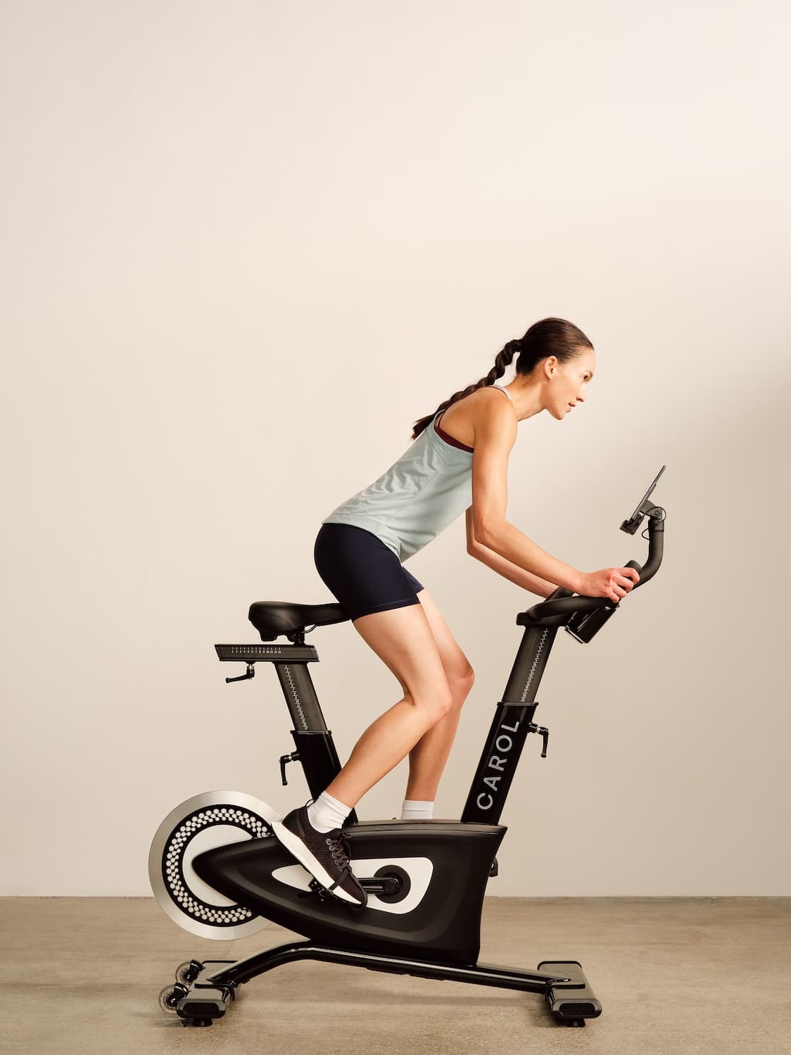 A woman using an a CAROL exercise bike