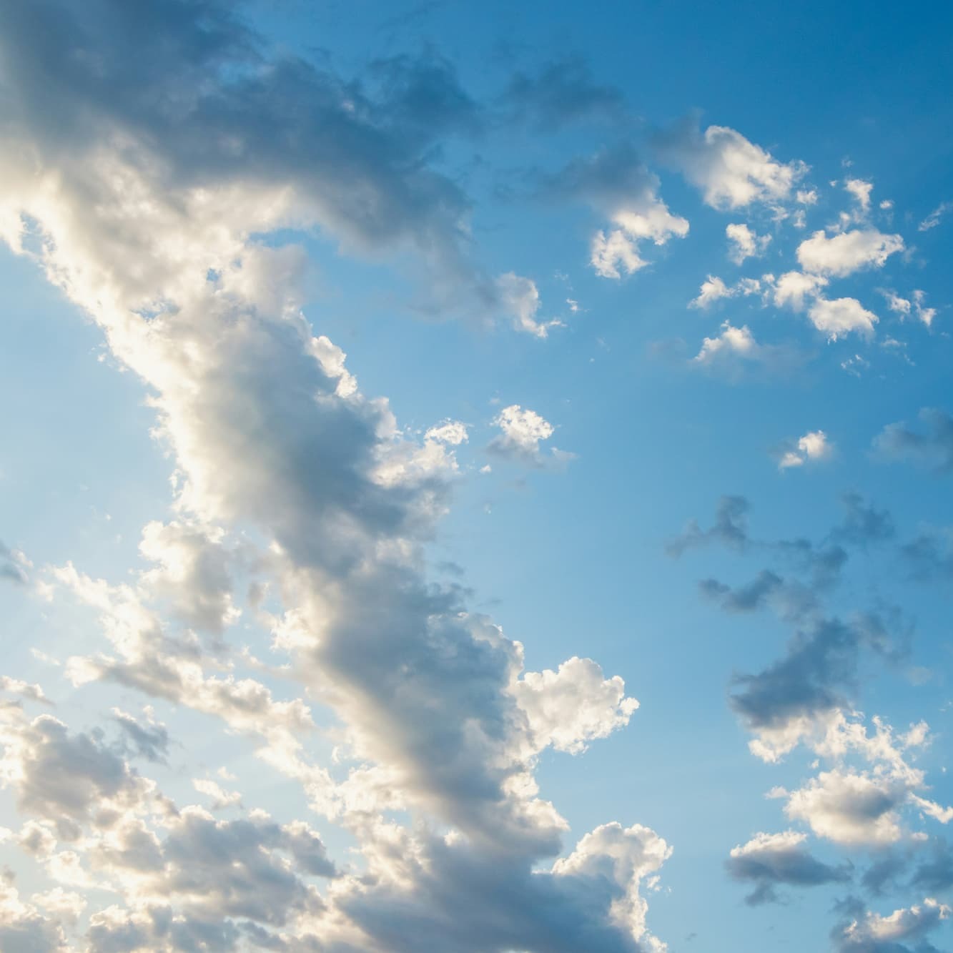 Blue sky with sunlit clouds