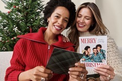 Two women smiling with personalized Shutterfly photo gifts