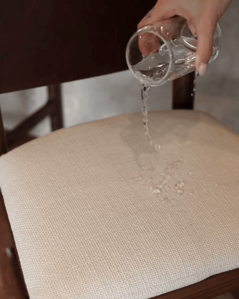 GIF of water being spilled and easily cleaned and the cushion being removed