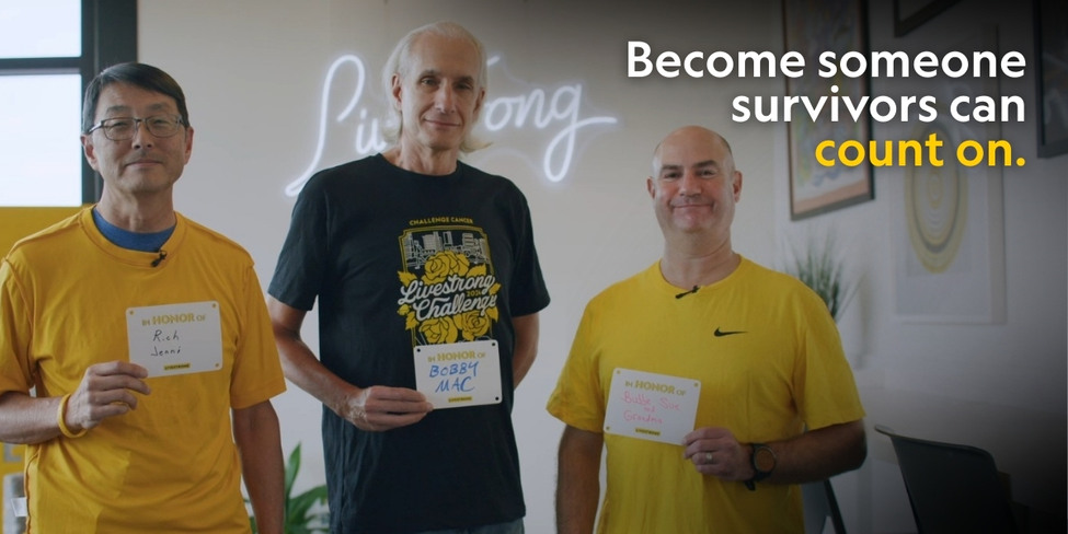 Three men holding cards with names