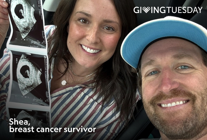 A woman and man holding up an ultrasound photo