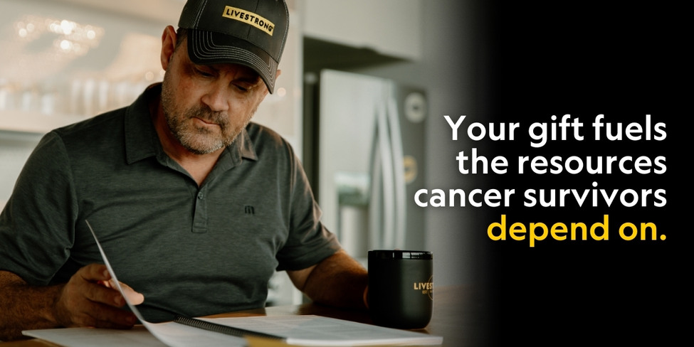 A man reading a magazine and holding a mug