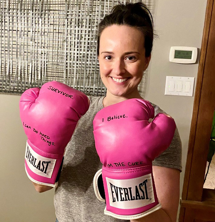 A woman with pink boxing gloves