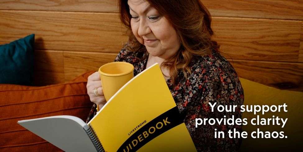 A woman reading and holding a mug
