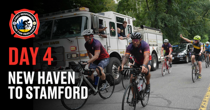 Man cycling past a firehouse