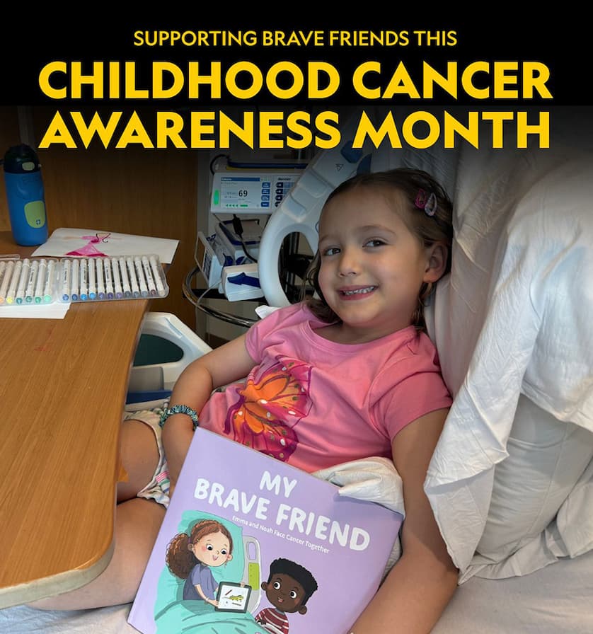 A young girl in a hospital bed holding a book