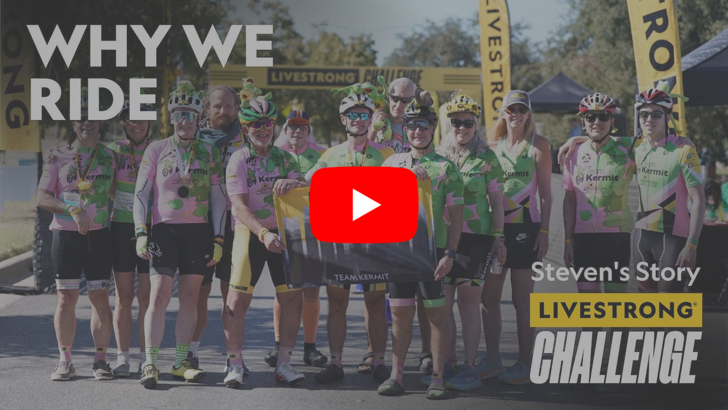 A team of cyclists holding a flag