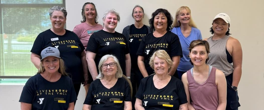 A group of smiling women in workout gear