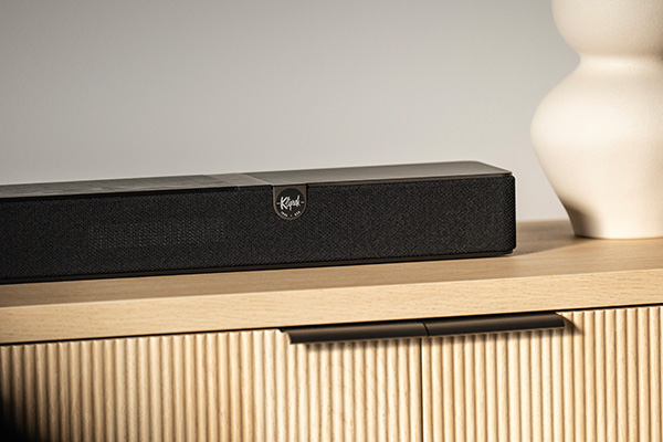 The Klipsch Flexus Core 200 Soundbar sitting on a side-table. The lighting is soft and warm.