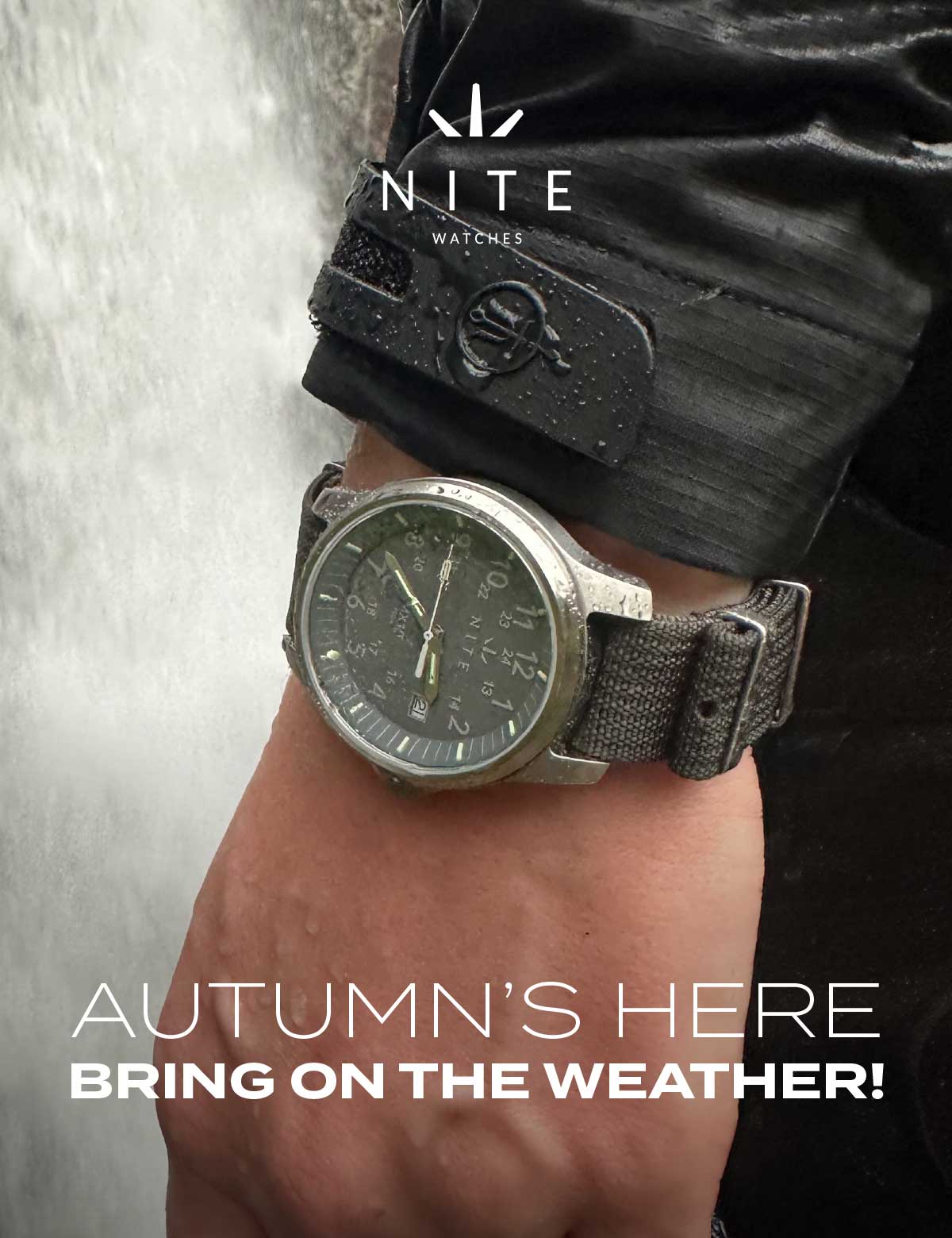 Watch with water droplets near waterfall