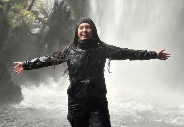 Chantelle standing by waterfall