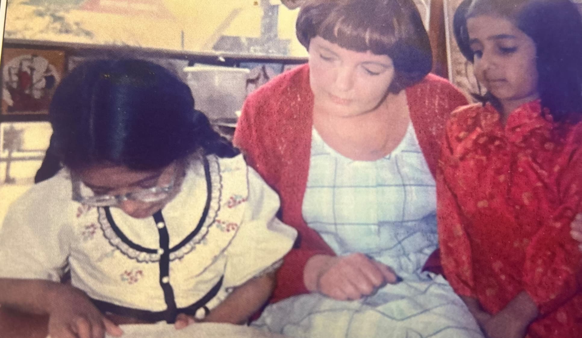 Mavis Clegg reading with two of her pupils