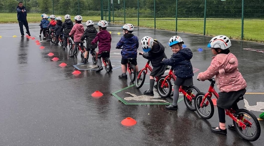 Group of children lined up on their bikes 