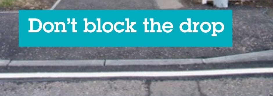 A dropped kerb with the message 'don't block the drop'