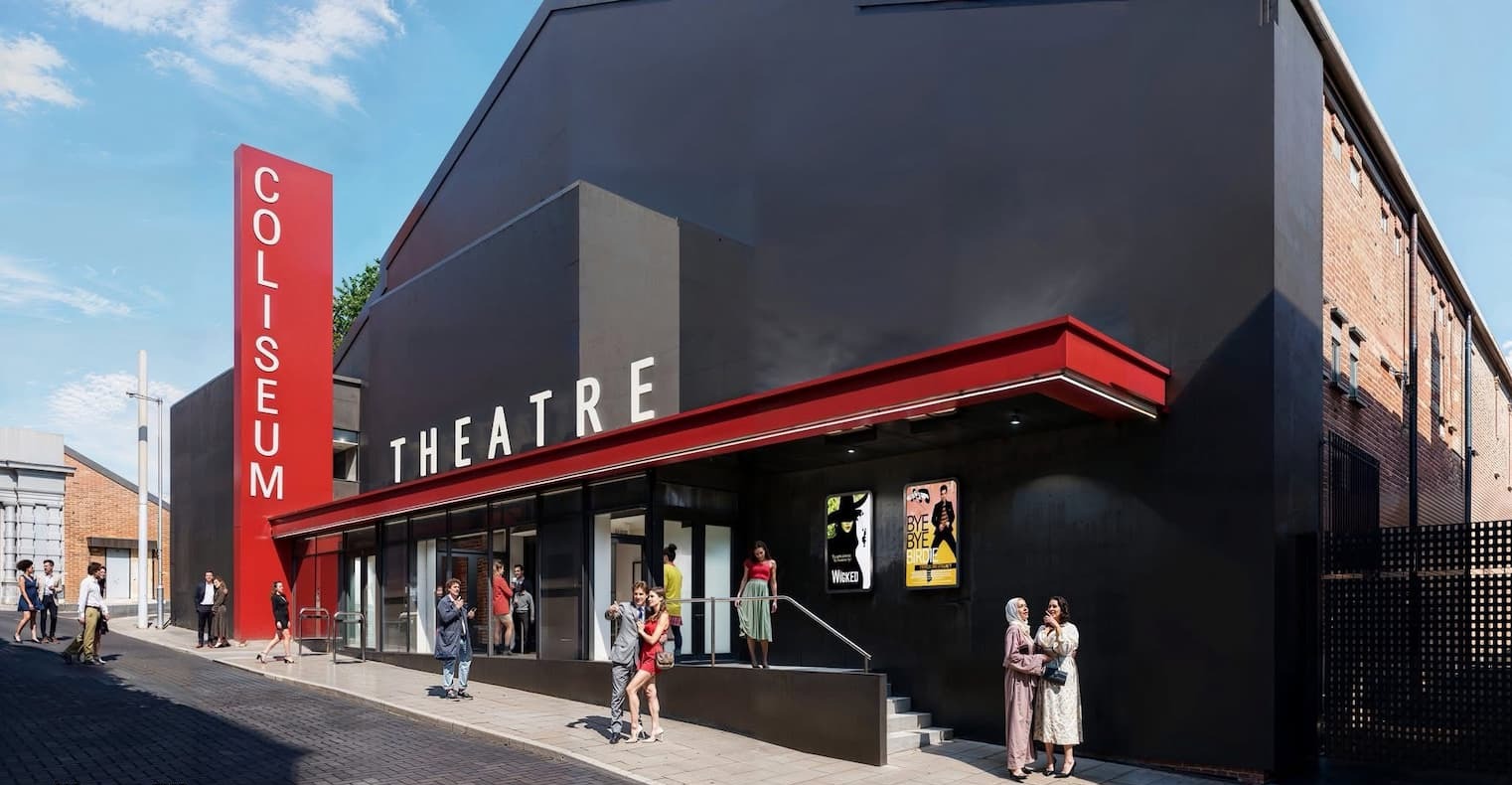 CGI image of an outside view of the new Coliseum - a black building with red canopy and a red vertical Coliseum sign