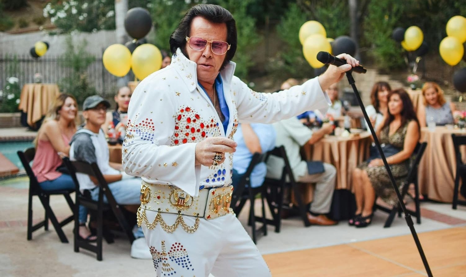 Elvis performer Chris Connor in a white Elvis style jewelled jumpsuit 