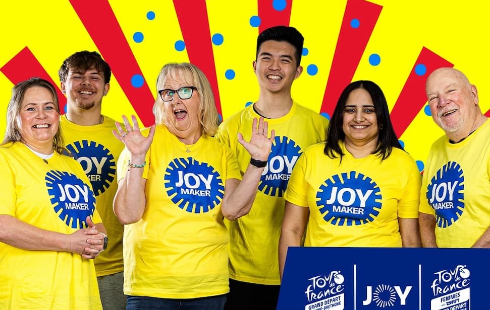 Residents wearing yellow T-shirts with a blue 'Joy Maker' slogan