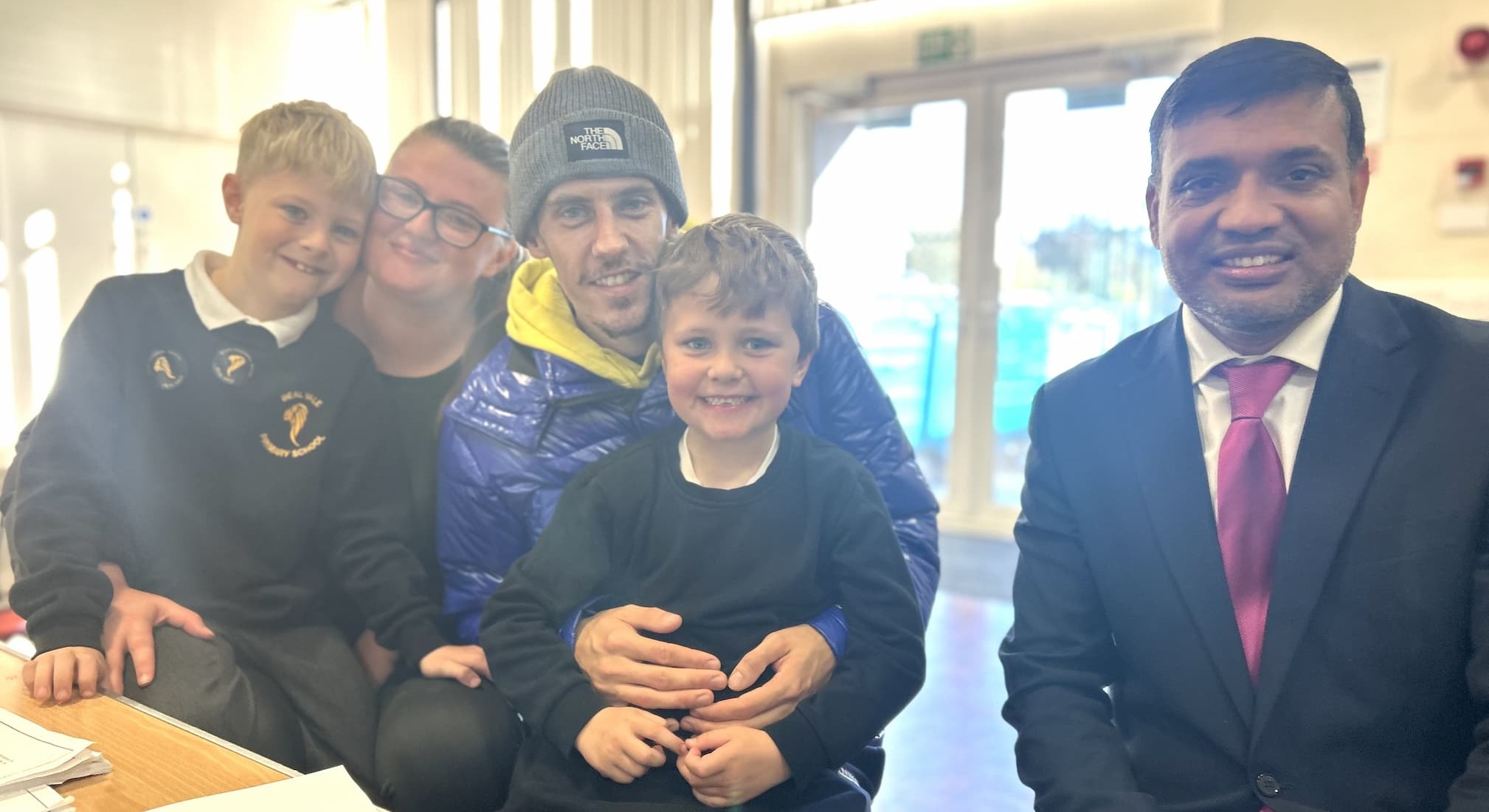 Carrigan Hoyle and Jake Davies and their sons, Silas and Theo, with Cabinet Member for Education and Skills Cllr Mohon Ali